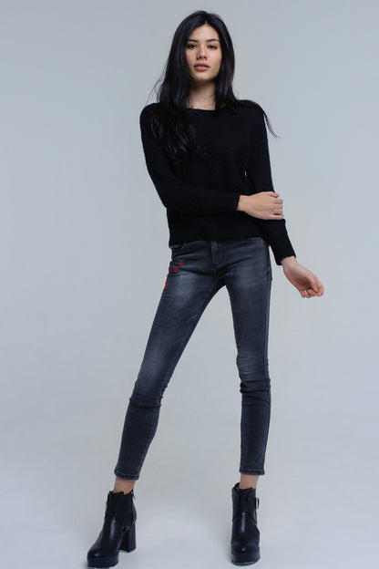 Black knitted sweater with tie-back closureSweaters