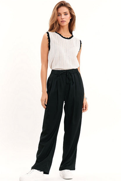 white knitted pointelle top with black wavy trim